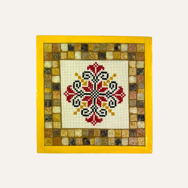 Palestinian flower embroidery art in red black and yellow thread framed with mosaic tiles by Pal-Mosaic
